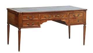 French Provincial Louis XVI Style Carved Walnut Desk, early 20th c., the gilt tooled black leather cookie corner ogee edge top over a center drawer fl