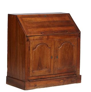 French Louis Philippe Carved Walnut Slant Front Desk, 19th c., the rectangular top over a slant lid opening to a gilt tooled black leather writing sur