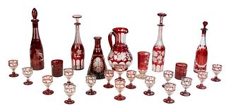 Group of Thirty Pieces Bohemian Cut-to-Clear Etched Ruby Glass Pieces, late 19th c., consisting of a pitcher with cut grape and etched leaf decoration