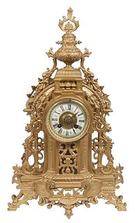 French Gilt Brass Mantel Clock, 19th c., with an urn and dolphin fish surmount, over a painted enamel dial time and strike drum clock, flanked by pier