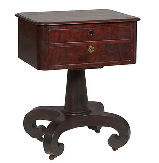 American Classical Carved Mahogany Work Table, 19th c., the rectangular top over a bank of two bowed drawers, on a turned tapered support to four spla