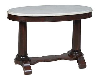 American Classical Carved Mahogany Oval Marble Top Center Table, 19th c., the ogee edge figured white marble over a wide skirt, on tapered hexagonal t