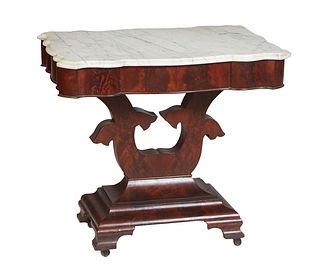 American Classical Carved Mahogany Marble Top Side Table, 19th c., the serpentine ogee edge figured white marble over a wide serpentine skirt, on a ly