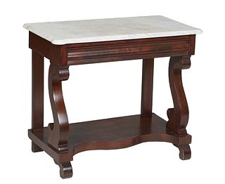 American Classical Carved Mahiogany Marble Top Side Table, 19th c., the ogee edge cookie corner white marble over a frieze drawer, on scrolled support