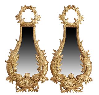 Pair of Carved Giltwood Flat Dolphin Form Mirrors, 20th c., of tapered form with relief leaf tops over tapered sides with relief leaves, H.- 45 1/2 in