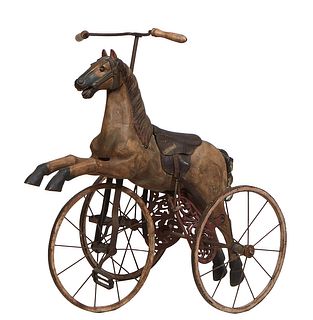 Unusual Carved Wooden Horse Tricycle, 20th c., with a leather saddle and stirrups, and a horse hair tail, with wooden handle bars stering the pedal dr