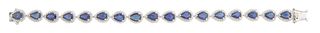 14K White Gold Link Bracelet, each of the seventeen pear shaped links with a graduated pear shaped sapphire, atop a conforming border of tiny round di