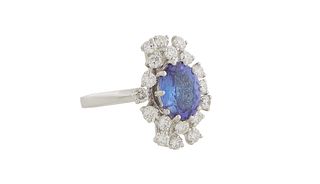 Lady's 18K White Gold Dinner Ring, with an oval 1.86 ct. tanzanite, atop a conforming undulating border of 18 round diamonds, total diamond wt.- .86 c