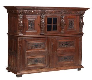 Belgian Renaissance Style Carved Oak Figural Sideboard, 19th c., the stepped crown over a lion and ring carved frieze, above triple cupboard doors fla