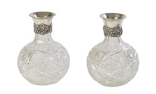 Pair of Cut Crystal and Sterling Carafes, late 19th c., of bottle form, the sterling silver necks with repousse floral, leaf and grape bunch mounts, m