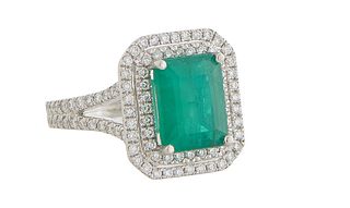 Lady's Platinum Dinner Ring, with a 3.53 ct. emerald atop a pierced double graduated concentric border of tiny round diamonds, the split shoulders of 
