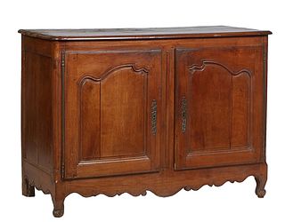 French Provincial Louis XV Style Carved Walnut Sideboard, 19th c., the stepped rounded edge and corner top over double fielded panel cupboard doors, w