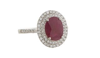 Lady's Platinum Dinner Ring, with an oval 3.69 ct. ruby atop a double graduated concentric border of round diamonds, the shoulders of the band also mo