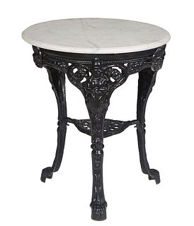 English Cast Iron "Brittania" Pub Table, 20th c., the ogee edge figured circular white marble top over a pierced skirt, on tripodal figural supports j