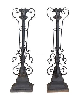 Pair of Wrought Iron Torcheres, 19th c., the torch form center on a square support flanked by scrolled appliques, to a stepped sloping base, also flan