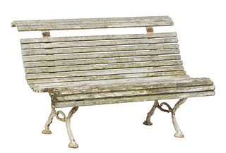 French Cast Iron and Beech Garden Bench, early 20th c., the rolled slat back over a rolled curved slat seat, on iron trestle bases, H.- 29 1/2 in., W.