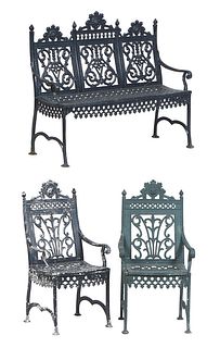 Three Piece Cast Iron Garden Set, 20th c., consisting of a three seat bench and two matching armchairs, all with pierced finialed backs over scrolled 