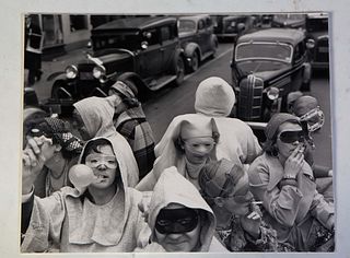 Theodore Fonville Winans (Missouri/Louisiana, 1911-1992), "Mardi Gras Revelers," 1938, photograph mounted on paperboard, signed and dated lower left, 