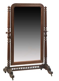 French Carved Oak Cheval Mirror, c. 1870, the arched relief carved lappet frame,around an ached plate, on turned tapered finial topped supports, to le