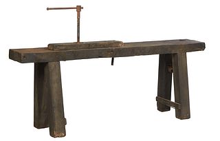 French Provincial Cabinet Maker's Oak Workbench, 19th c., the thick top mounted with a wood vise, on large splayed block legs joined by a lower rectan