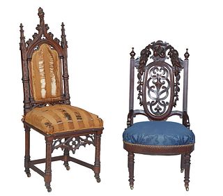 Two Carved Mahogany Side Chairs, 19th c., one with a Gothic Arch crest rail, flanked by turned tapered spires over a cushioned back, to a tapered trap
