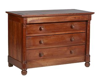 French Provincial Empire Carved Cherry Commode, 19th c., the rectangular top over three setback deep drawers flanked by turned cylindrical columns, on