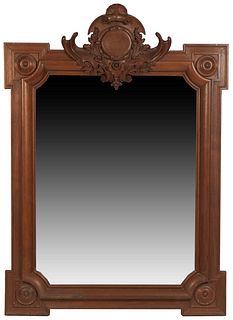 French Louis XV Style Carved Walnut Overmantel Mirror, 19th c., with a shell and leaf carved crest above a relief orb, and a wide frame with square co