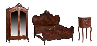 French Louis XV Style Carved Kingwood Bedroom Suite, late 19th c., consisting of a bombe armoire, the arched stepped C-scroll crest over an arched fri