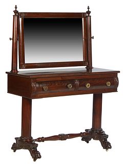 American Classical Carved Mahogany Dressing Table, 19th c., the rectangular swivel mirror on turned tapered finial topped cylindrical supports, to a b