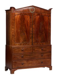 English Ormolu Mounted Carved Mahogany Linen Press, 19th c., the peaked crown with an ormolu wreath over double figured doors opening to four pullout 
