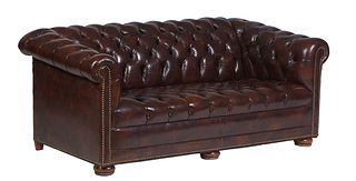 Brown Faux Leather Chesterfield Sofa, 20th c., with a tufted rolled back and arms, with iron tack decoration, on turned bun feet, H.- 28 in., W.- 66 i
