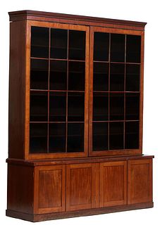 Large English Georgian Style Carved Mahogany Bookcase, 20th c., the stepped ogee crown over a setback upper section with two large mullioned glazed do