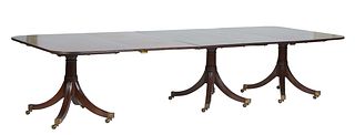 English Georgian Style Carved Mahogany Triple Pedestal Dining Table, 20th c., the curved ribbed edge top in three parts, on three turned tapered suppo