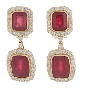 Pair of Unusual 14K White Gold Earrings, the stud with a rectangular cut ruby atop an octagonal border of round diamonds, suspending a cushion cut rub