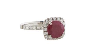 Lady's Platinum Dinner Ring, with a round 2.32 ct. Burmese ruby atop a border of small round diamonds, the shoulders of the band also mounted with tin