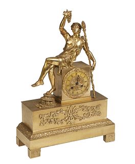 French Bronze Figural Mantel Clock, with a figure of a seated Bacchante upholding a bunch of grapes in her right hand and a staff in her left, atop a 