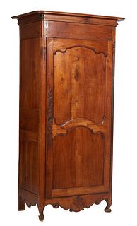 French Provincial Louis XV Style Carved Cherry Bonnetiere, early 20th c., the stepped rounded corner crown over a double panel door with a long iron f