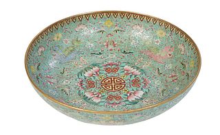 Chinese Famille Rose Footed Porcelain Green Serving Bowl, 19th c., with a gilt rim over a gilt tracery border, around floral, dragon and bat decoratio
