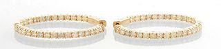 Pair of 14K Yellow Gold Oval Hoop Earrings, each mounted with 26 round diamonds, total diamond wt.- 3 cts., H.- 1 1/2 in., W.- 1 1/8 in., with apprais