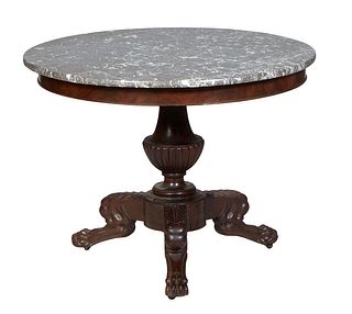American Classical Carved Mahogany Marble Top Center Table, 19th c., the highly figured circular gray marble over a wide skirt, on a tapered reeded ba