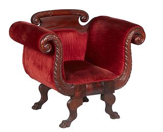 American Classical Carved Mahogany Armchair, 19th c., the arched scrolled crest rail over a cushioned back flanked by rolled scrolled arms to a cushio