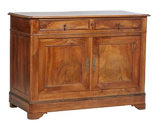 French Empire Style Louis Philippe Carverd Walnut Sideboard, 19th c., the stepped canted corner rounded edge top over two frieze drawers above double 