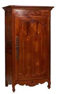 French Provincial Louis XV Style Carved Cherry Bonnetiere, 19th c., the stepped rounded corner ogee crown over a paneled door with a long iron fiche h