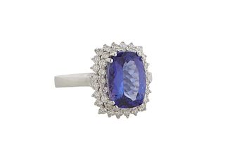 Lady's 18K White Gold Dinner Ring, with a 3.76 carat cushion cut tanzanite, atop a double concentric graduated border of tiny round diamonds, total di