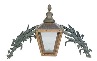 Larged Cast Iron and Copper Entryway Gas Lantern, 20th c., with a turned finial top over tapered glass sides, on double arched cast iron relief cornst