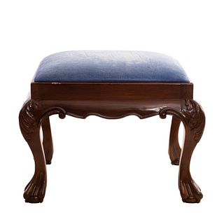 TABURETE. SXX. Estilo CHIPPENDALE. Elaborado en madera. Con asiento acojinado, tapicería de tela color azul y soportes tipo garra.