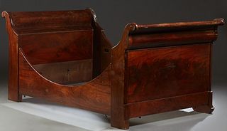 French Louis Philippe Carved Walnut Sleigh Bed, 19th c., the scrolled sleigh ends on stepped rectangular supports with ogee block feet, joined by two 