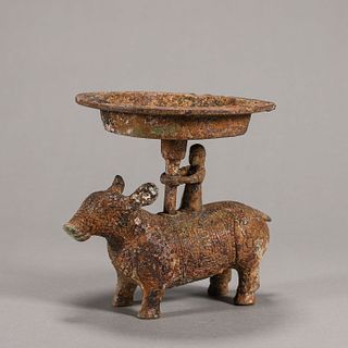 A copper plate with beast and figure pedestal