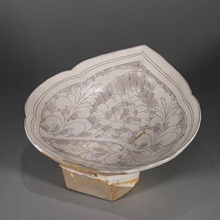 A peony carved Cizhou kiln white glazed porcelain lotus leaf pillow