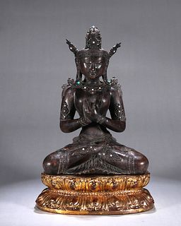 An aloeswood Guanyin statuette with gilt copper pedestal